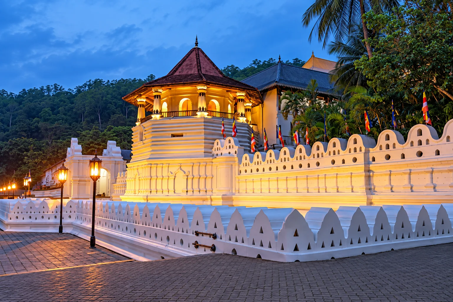 The white octagonal Pattirippuwa tower of the Temple of the Sacred Tooth above the moat at Kandy
