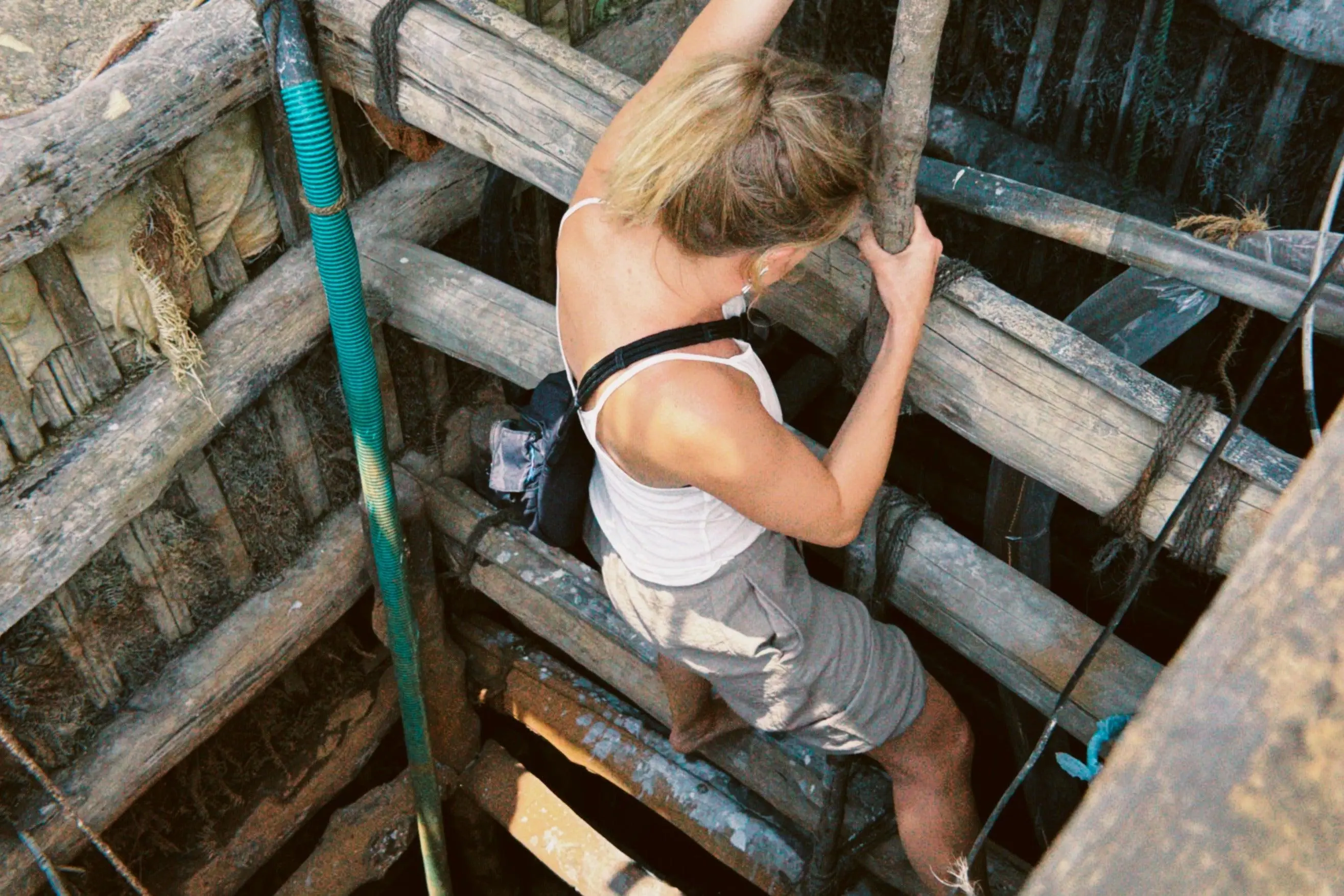 Down into the pit by hand, the earth lifted out basket by basket until the gem gravel shows.
