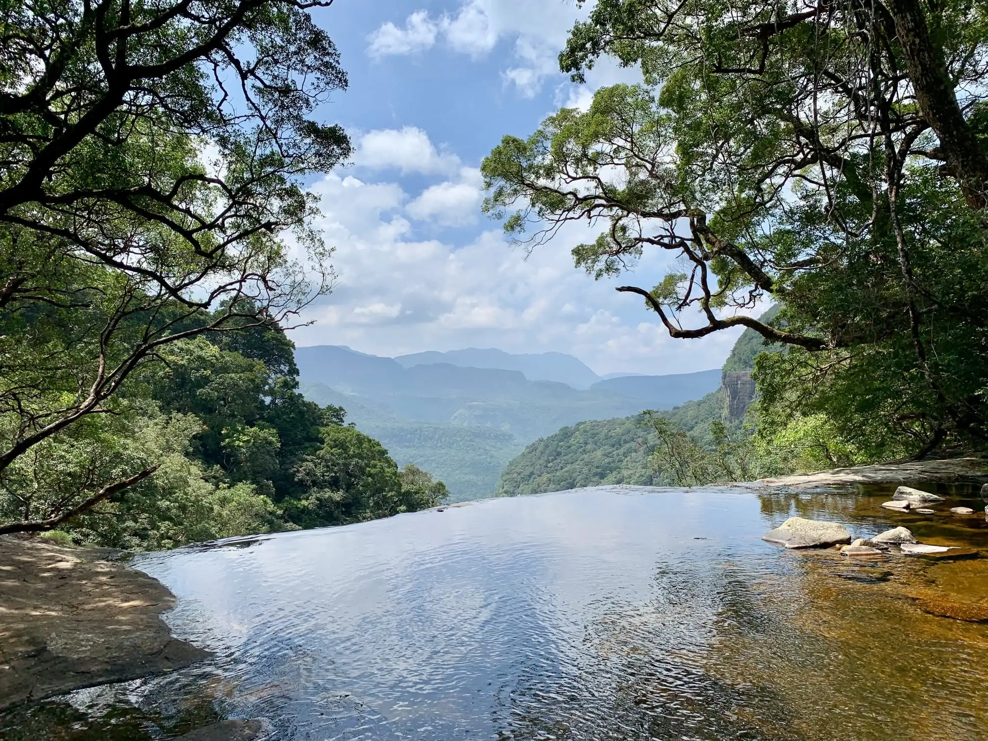 A rock pool in the Knuckles foothills, forest on three sides, and a day with nothing in it on purpose.